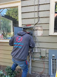 Nodine Electric Electrician Inspecting Electrical Panel